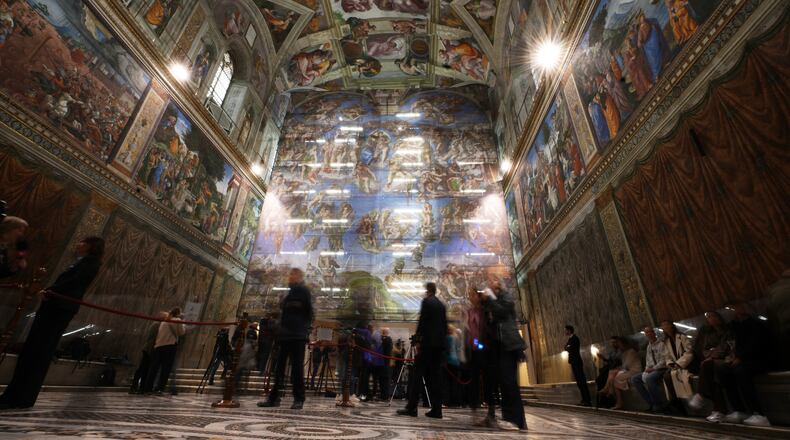A screen with a replica of “The Last Judgment,” superimposed on it covers the scaffolding used for its extraordinary maintenance during a presentation for press in the Sistine Chapel at the Vatican, Saturday, Feb. 28, 2026. (AP Photo/Alessandra Tarantino)