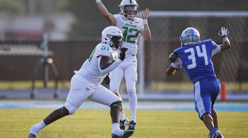 Badin quarterback Alex Ritzie tosses a pass against Hamilton at Virgil Schwarm Stadium on Friday, Aug. 18, 2023. Nick Graham/STAFF