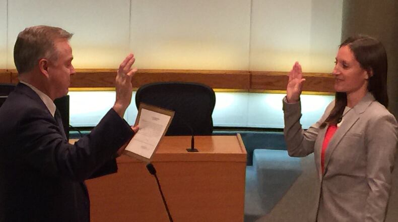 Middletown Municipal Court Judge James Sherron adminsters the oath of office to Nicole Condrey as Middletown’s first woman mayor. Condrey, 37, will take office on Jan. 1. ED RICHTER/STAFF