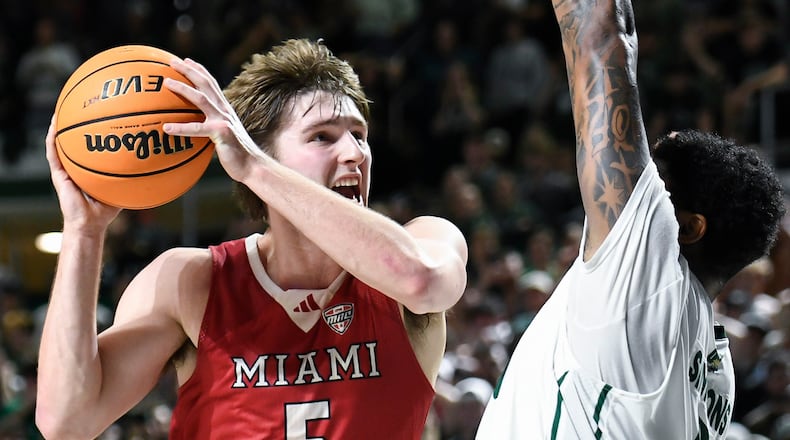 Miami (Ohio) guard Luke Skaljac (5) drives into Ohio forward Javan Simmons (1) during the second half of an NCAA college basketball game against Ohio, Friday, March 6, 2026, in Athens, Ohio. (AP Photo/HG Biggs)