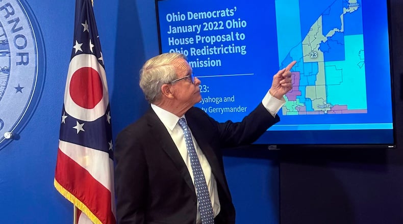 Ohio Gov. Mike DeWine points to a map during a press conference in Columbus, Ohio, Wednesday, July 31, 2024, where he opposed a fall ballot measure aimed at remaking the state's troubled political mapmaking system. If it passes, DeWine said he will work with state lawmakers next year to advance a competing amendment based on the Iowa model. (AP Photo/Julie Carr Smyth)