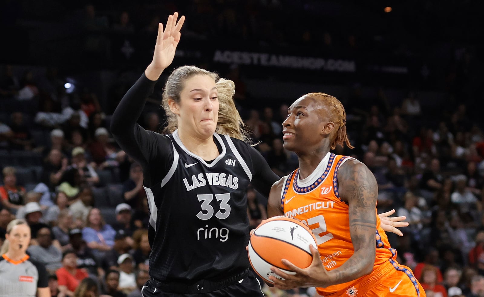 Connecticut Sun guard Saniya Rivers (22) drives to the basket against Las Vegas Aces center Elizabeth Kitley (33) during the first half of a WNBA basketball game Wednesday, June 25, 2025, in Las Vegas. (Steve Marcus/Las Vegas Sun via AP)