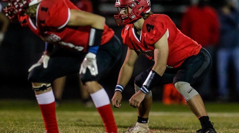 Madison defensive back Jake Valerio (1) and linebacker Devin Oligee (4) get ready for the snap during their football game against Carlisle Friday, Sept. 18, 2020 at Madison High School in Madison Township. Madison won 30-20. NICK GRAHAM / STAFF