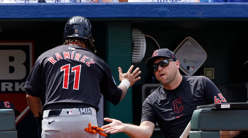 Cleveland Guardians Jose Ramirez (11) is congratulated by hitting coach Chris Valaika (45) after scoring off a Josh Naylor single during the eighth inning of a baseball game against the Kansas City Royals in Kansas City, Mo., Sunday, June 30, 2024. (AP Photo/Colin E. Braley)