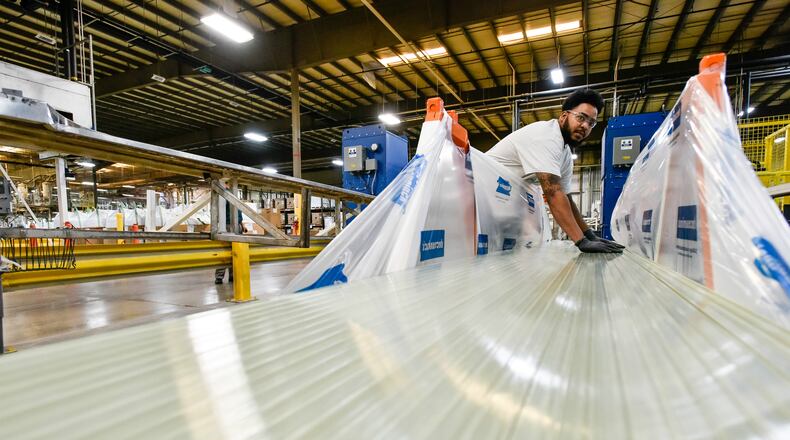 Deceuninck North America announced this week it will temporarily lay off 125 employees at its Monore plant due to the novel coronavirus, COVID-19. Pictured in October 2019 is Tryvale Redmond as he stacks extruded fiberglass products at Deceuninck North America. NICK GRAHAM/FILE