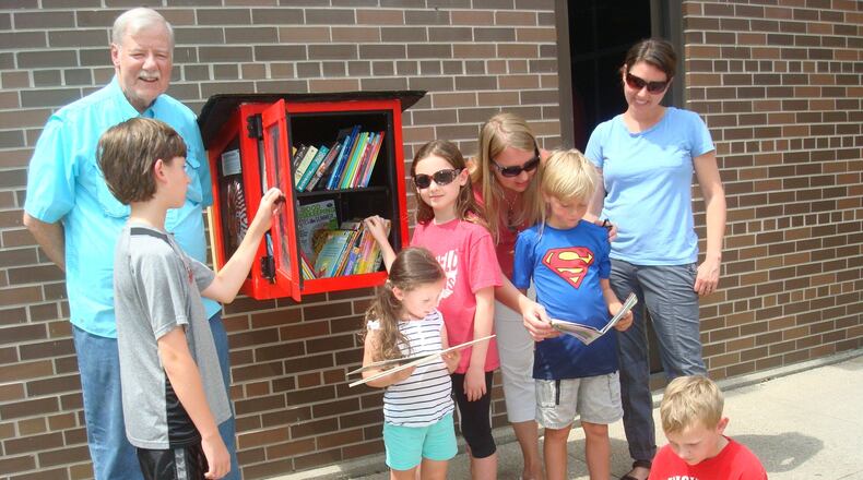 The Little Free Library, which allows people to not only borrow books but donate them as well, is now available at two new locations: Fairfield South Elementary School, 5460 Bibury Road, and Fairfield Family YMCA, 5220 Bibury Road. Pictured at the school location is Community Connection Group chairman and founder Howard Dirksen with grandchildren Elijah, Olive and Piper Parsell along with PTC President Carri Mefford and her sons, Colin and Grant (seated), plus daughter and PTC member Ann Parsell. CONTRIBUTED