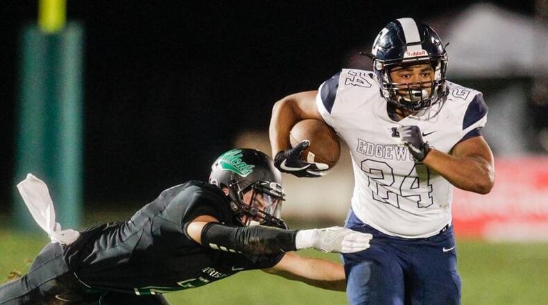 Edgewood’s Elijah Williams breaks free from a tackle attempt by Harrison’s Blake Cox during a game Sept. 21 at Harrison’s Bill Kuntz Field. Edgewood won 42-35. NICK GRAHAM/STAFF