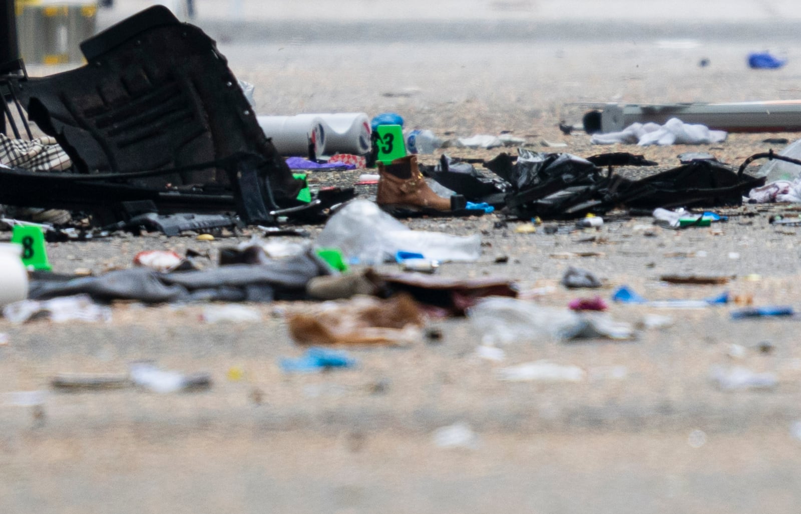 Debris and evidence markers lay on the street while police investigate after a vehicle drove into a crowd at a street festival Saturday evening killing multiple people, in Vancouver, British Columbia, Sunday, April 27, 2025. (Rich Lam/The Canadian Press via AP)