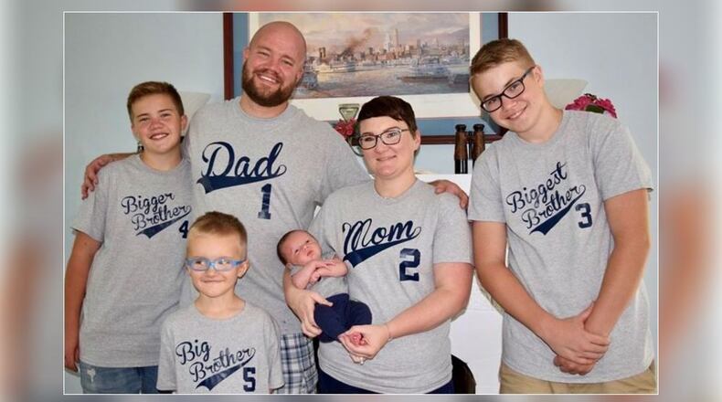 Paul Jewett, who died Saturday at 37 from Covid, with his wife and sons. PROVIDED