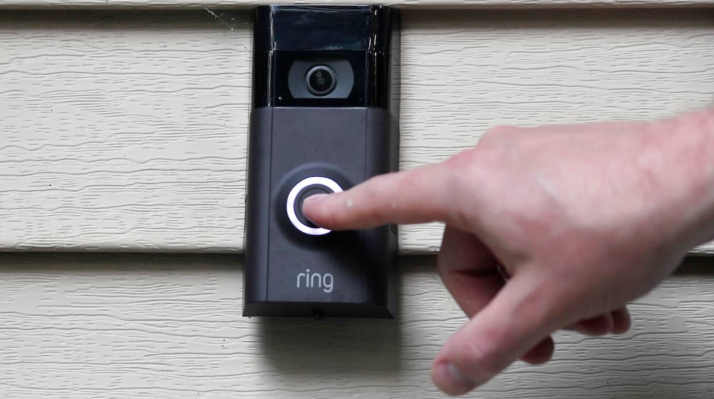 FILE - A person pushes the doorbell on their Ring doorbell camera, July 16, 2019, in Wolcott, Conn. (AP Photo/Jessica Hill, File)