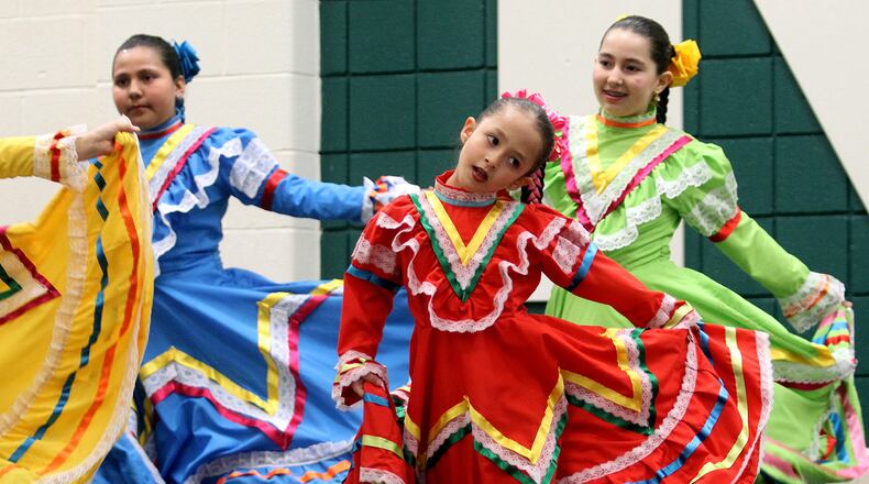 Isabella Rojo, 6, in red, dances with the Cincinnati Baila! Dance Academy during the Mason City Schools Diversity Council’s sixth annual Taste of Mason at Mason High School Commons in Mason Wednesday, Feb. 6, 2013. CONTRIBUTED PHOTO BY E.L. HUBBARD
