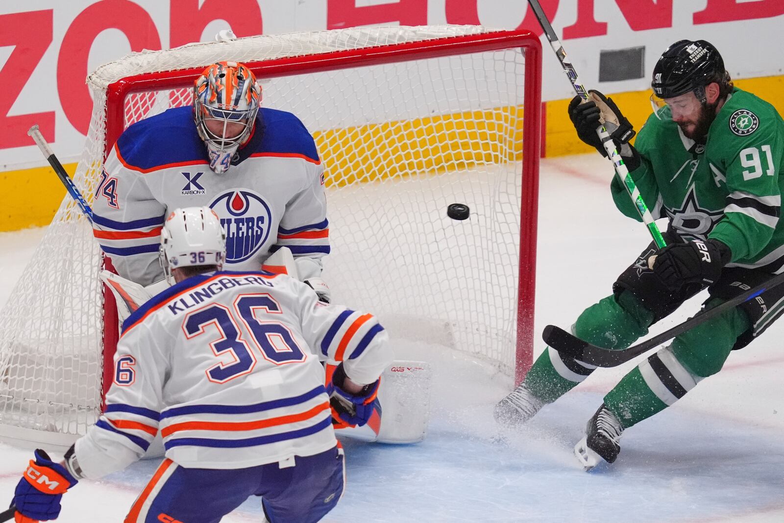 Edmonton Oilers goaltender Stuart Skinner (74) and defenseman John Klingberg (36) defend the goal against Dallas Stars center Tyler Seguin (91) during the third period in Game 1 of the Western Conference finals in the NHL hockey Stanley Cup playoffs Wednesday, May 21, 2025, in Dallas. (AP Photo/LM Otero)