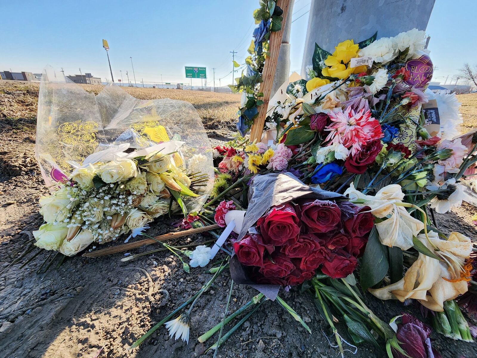 Flowers lay at the site where Dustin Booth died after he was shot during an incident with Monroe police, which took pace near Garver Road and Ohio 63. NICK GRAHAM / STAFF