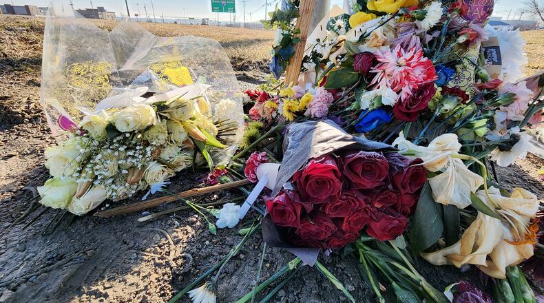 Flowers lay at the site where Dustin Booth died after he was shot during an incident with Monroe police, which took pace near Garver Road and Ohio 63. NICK GRAHAM / STAFF