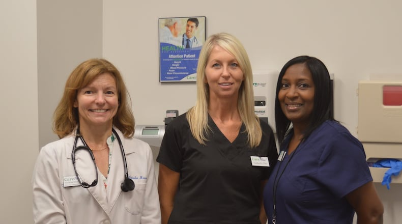 Shown in one of the exam rooms at the Butler Advantage Health & Wellness Center are, from left, Dr. Natasha Moore, DO, the site s medical director; Kandice Dooley, a certified medical assistant; and Debra Viverette RN, the office manager. CONTRIBUTED/BOB RATTERMAN