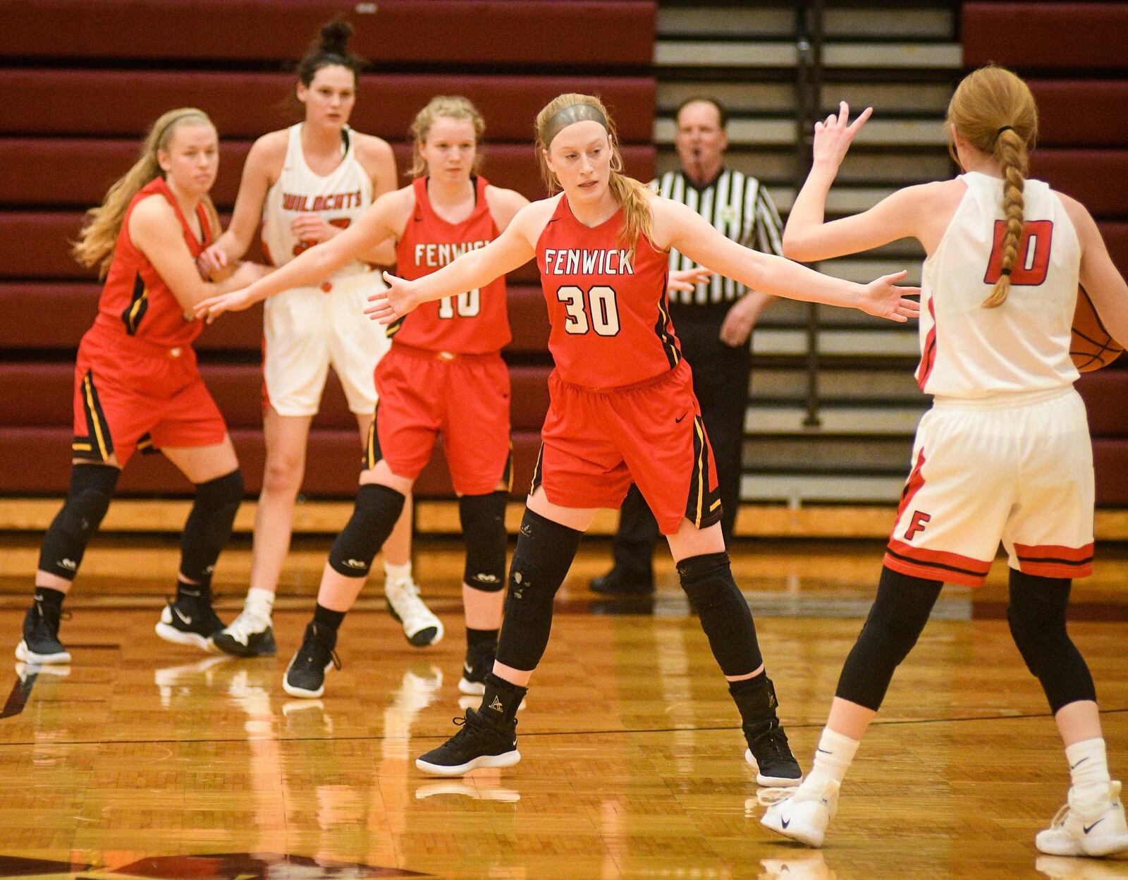 Fenwick’s Elena Daly (30) defends Franklin’s Jordan Rogers (10) during Monday night’s Division II district basketball semifinal at Lebanon. Franklin won 47-35. ROB MCCULLEY/RAM PHOTOGRAPHY