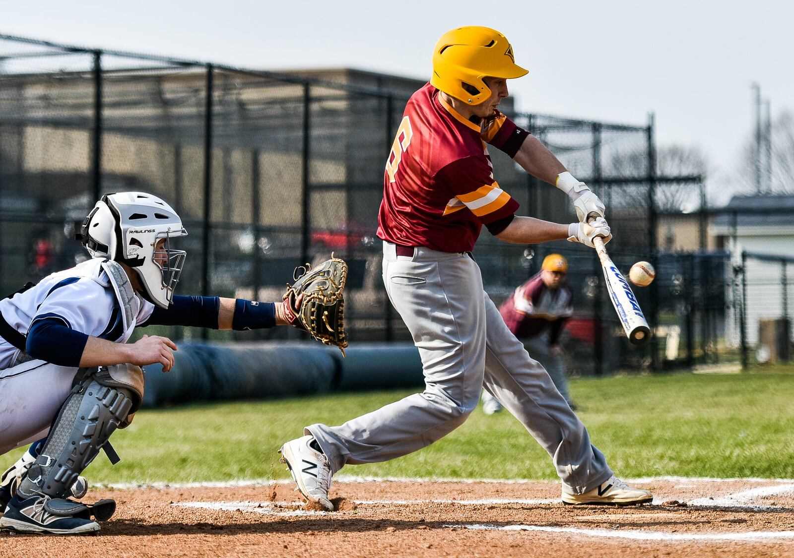 Andrew Beebe of Ross connects with a pitch toward Edgewood catcher Corbin Craft during Wednesday’s game in St. Clair Township. NICK GRAHAM/STAFF