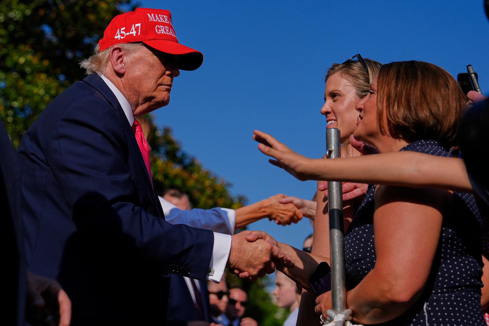 President Donald Trump and first lady Melania Trump greet guests after he signed his signature bill of tax breaks and spending cuts at the White House, Friday, July 4, 2025, in Washington. (AP Photo/Julia Demaree Nikhinson)