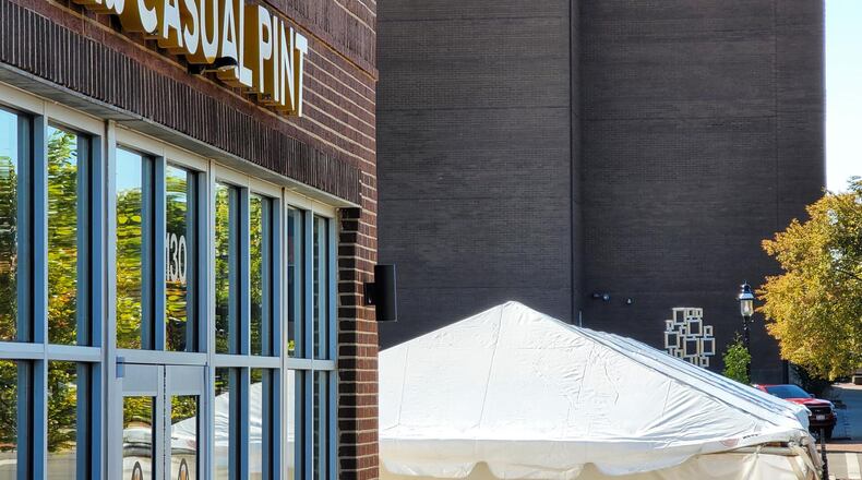 The Casual Pint Hamilton, 130 Riverfront Plaza, has opened a tent to expand its capacity as a way to serve customers through the winter. NICK GRAHAM/STAFF