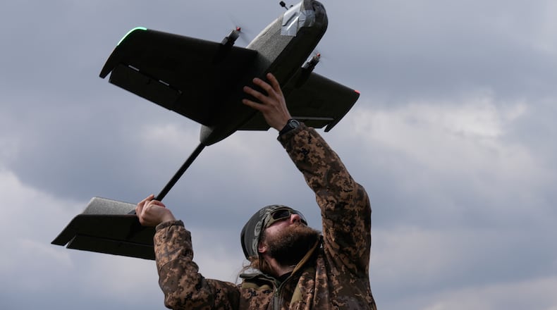 A student soldier of the Yatagan School for Unmanned Aerial Systems launches a training target drone during drills in the Kyiv region, Ukraine, Thursday, March 19, 2026. (AP Photo/Efrem Lukatsky)