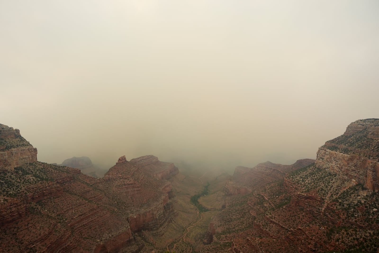 Smoke from the Dragon Bravo Fire moves over the Grand Canyon from the North Rim, Monday, July 14, 2025, in Grand Canyon National Park, Ariz. (AP Photo/Ross D. Franklin)