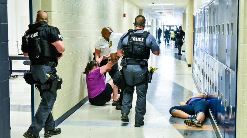 Hamilton High School and the city’s police department conducted a mock, active-shooter attack earlier this summer on the school campus in preparation for upgrading security in the coming school year. NICK GRAHAM/STAFF
