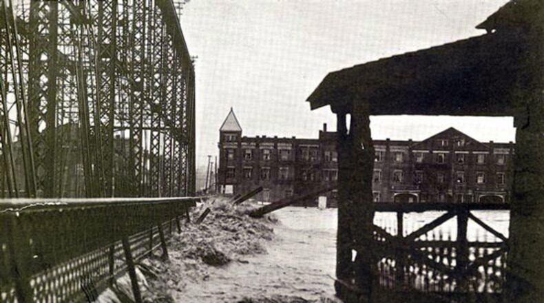 A photo of the great flood of 1913 in downtown Hamilton. It shows that water rising and was taken right before the bridge went down as a result of the rising waters.