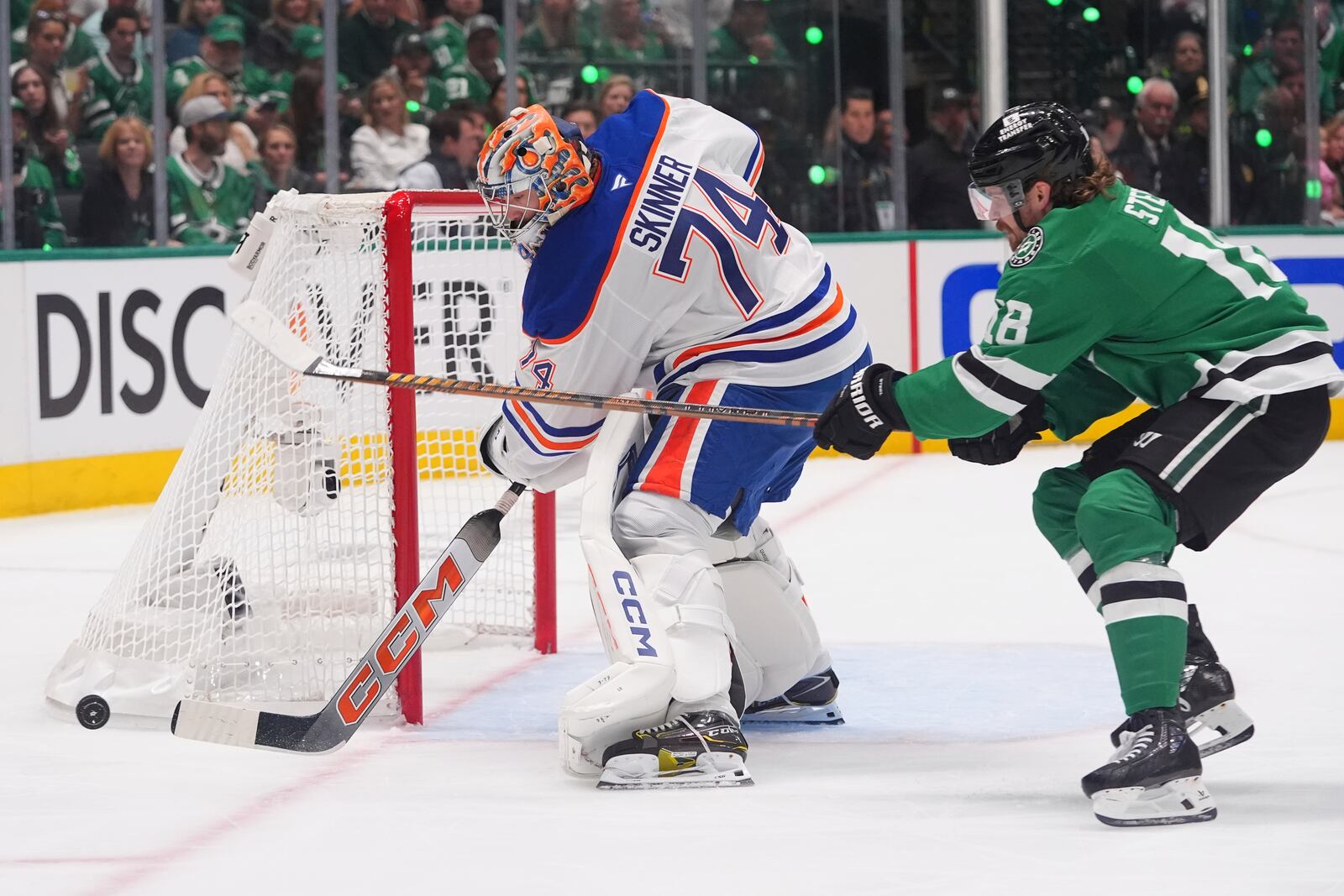 Edmonton Oilers goaltender Stuart Skinner (74) clears the goal against Dallas Stars center Sam Steel (18) during the first period in Game 1 of the Western Conference finals in the NHL hockey Stanley Cup playoffs Wednesday, May 21, 2025, in Dallas. (AP Photo/LM Otero)
