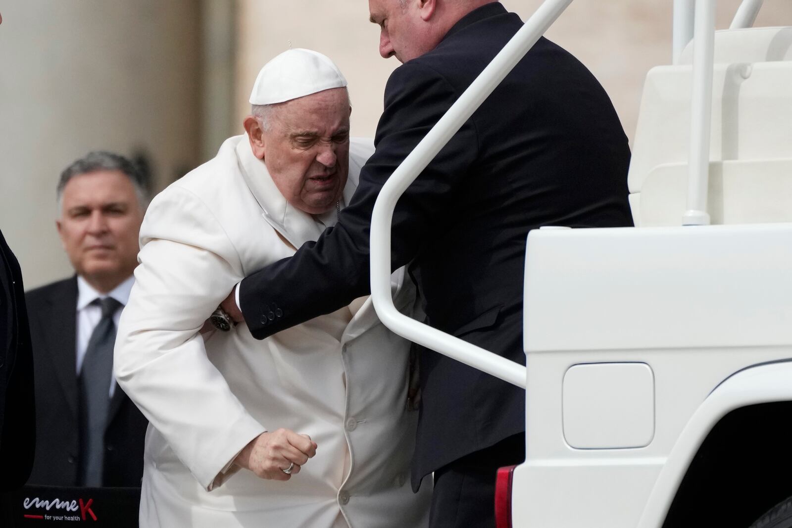 Pope Francis helped to get on his car at the end of weekly general audience in St. Peter's Square, at the Vatican, Wednesday, March 29, 2023. Pope Francis went to a Rome hospital on Wednesday for some previously scheduled tests, slipping out of the Vatican after his general audience and before the busy start of Holy Week this Sunday. (AP Photo/Alessandra Tarantino)