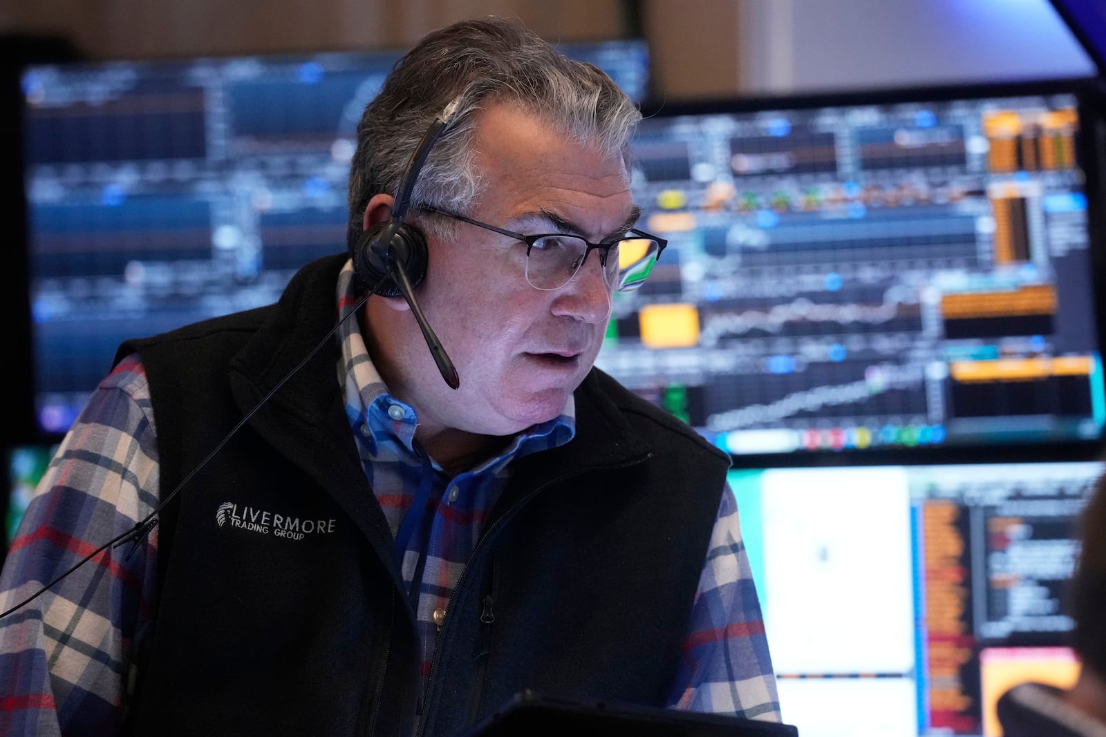 Trader John Bishop works on the floor of the New York Stock Exchange, Thursday, April 10, 2025. (AP Photo/Richard Drew)