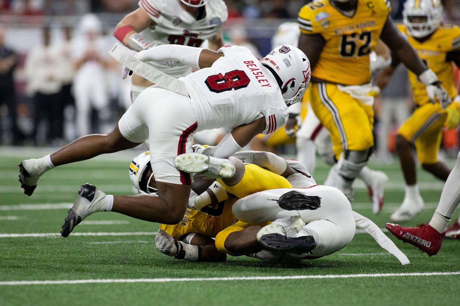 Western Michigan running back Jalen Buckley (6) gets tackled by Miami (Ohio) defensive back Koy Beasley (8) in the first half of the Mid-American Conference championship NCAA college football game on Saturday, Dec. 6, 2025, in Detroit. (Abra Richardson /Ann Arbor News via AP)