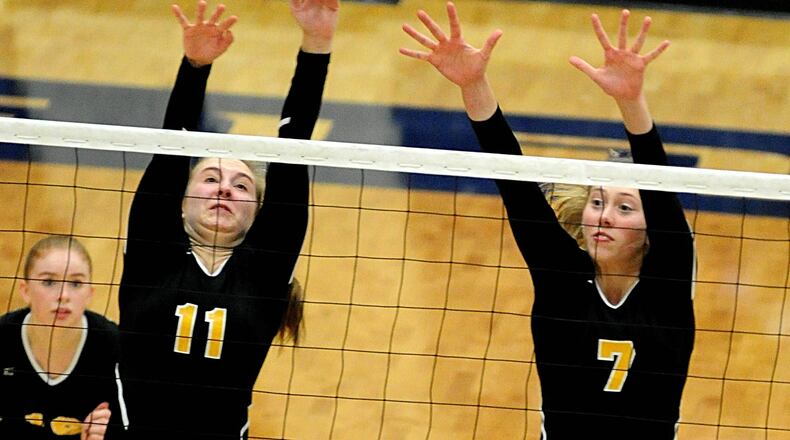 Fenwick’s Rose Porter (11) and Blaise Chaney (7) attempt to block a shot during a Division II district volleyball final against Kenton Ridge on Saturday at Fairmont’s Trent Arena. CONTRIBUTED PHOTO BY DAVID A. MOODIE