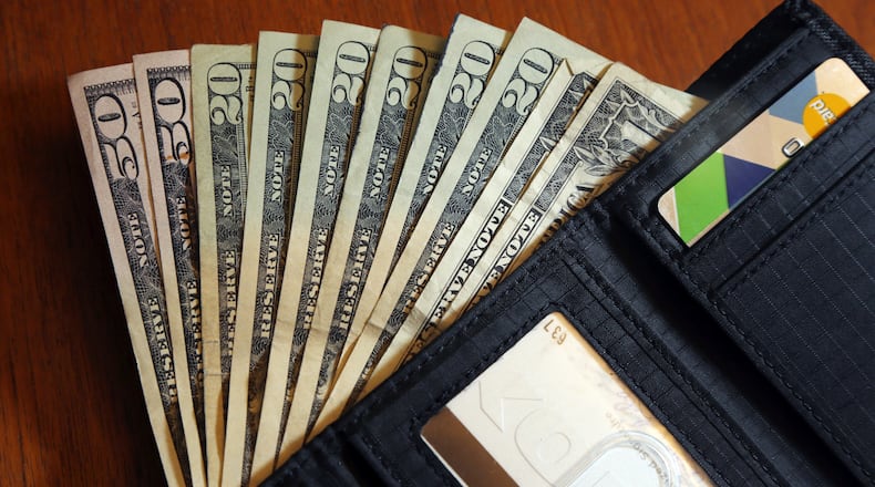FILE - In this June 15, 2018, file photo, cash is fanned out from a wallet in North Andover, Mass. Financial shocks are bound to hit at some point, and building financial resilience can make it easier to handle them when they do. Financial resilience means being able to get through a difficult time, whether it’s a surprise bill or a layoff. To strengthen your financial resilience, it helps to cut back on unnecessary expenses, build a savings reserve and protect your credit so it’s available if you need it. (AP Photo/Elise Amendola, File)