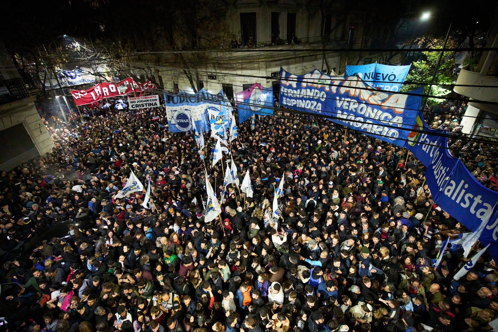 Supporters of former President Cristina Fernandez gather in front of her home after Argentina's Supreme Court upheld her corruption conviction, in Buenos Aires, Argentina, Tuesday, June 10, 2025. (AP Photo/Rodrigo Abd)