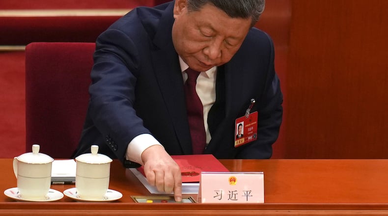 Chinese President Xi Jinping, presses a button to cast his vote during the closing session of the National People's Congress (NPC) at the Great Hall of the People in Beijing, Thursday, March 12, 2026. (AP Photo/Ng Han Guan)
