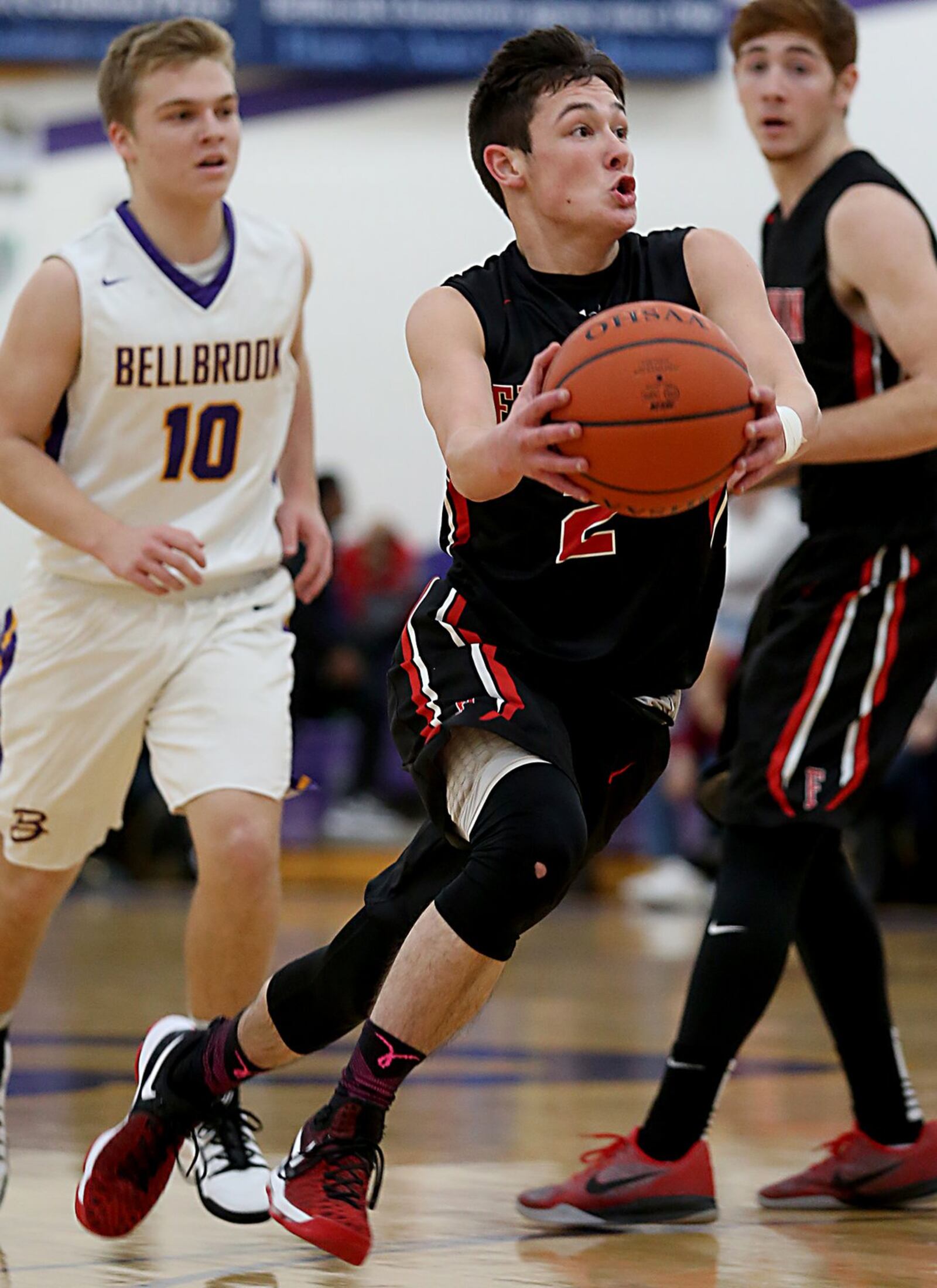 Franklin’s Payton Knott drives past teammate Noah Kremer and Bellbrook’s Ethan Savey (10) on Friday night at Bellbrook. CONTRIBUTED PHOTO BY E.L. HUBBARD
