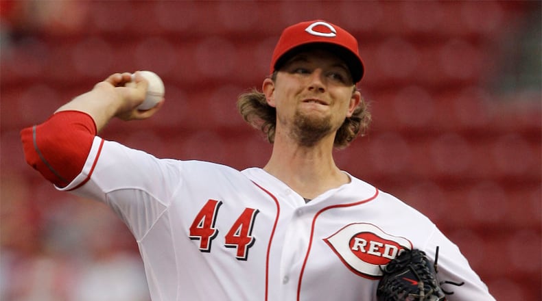 Cincinnati Reds starting pitcher Mike Leake throws against the Chicago Cubs in the first inning of a baseball game, Tuesday, Sept. 13, 2011 in Cincinnati.