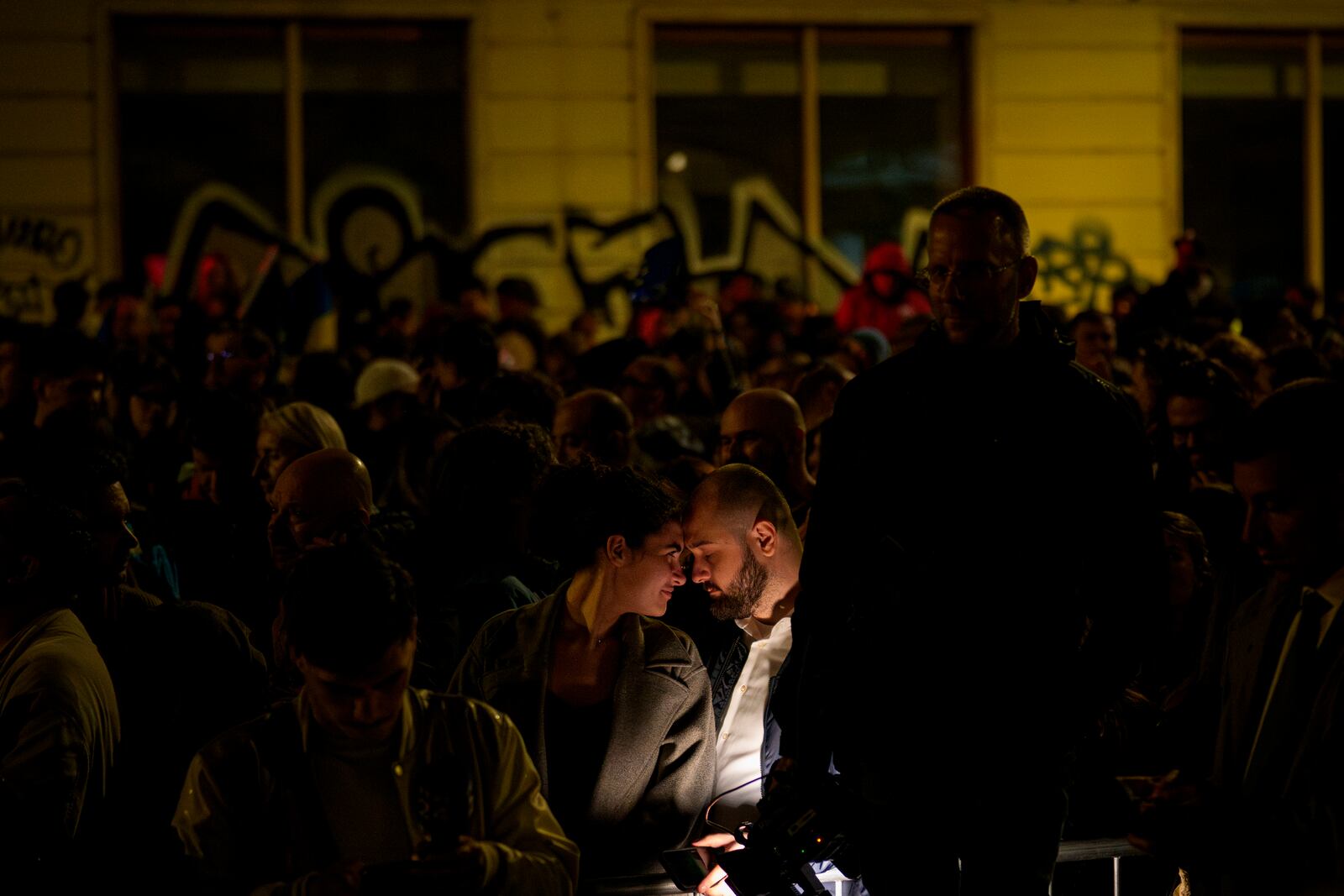 Supporters of presidential candidate Nicusor Dan touch foreheads after polls closed for the second round of the country's presidential election redo in Bucharest, Romania, Sunday, May 18, 2025. (AP Photo/Andreea Alexandru)