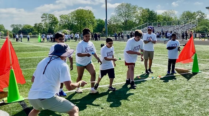 The universal joy of sports and friendly competition was showcased May 8 in the annual “Middie Olympics” for hundreds of special needs students from this city’s school system. The students from all 10 Middletown schools were joined by their families and friends in the sports-themed celebration that saw them participating in modified races and other athletic and non-sport activities. Pictured is the popular egg race, where students compete while balancing eggs on wooden spoons. MICHAEL D. CLARK/CONTRIBUTED