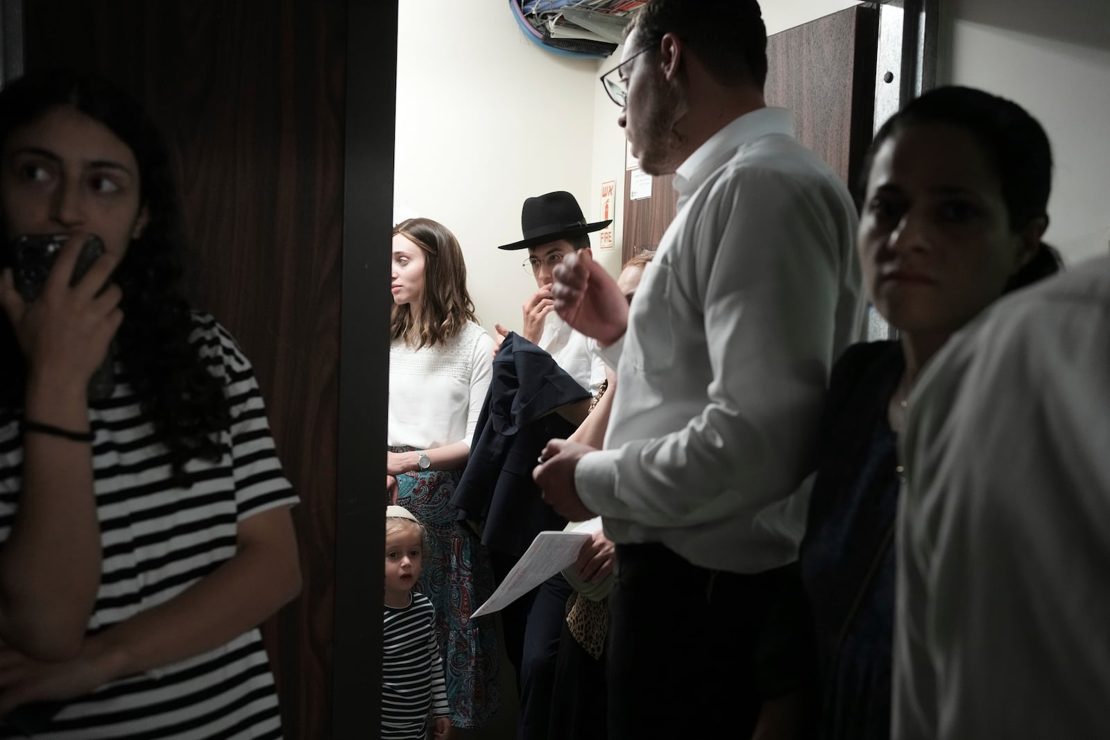 People take shelter during sirens warning of incoming fire at Israel's Magen David Adom emergency service during a blood drive to prepare for mass casualties in the event of strikes by Iran, in Jerusalem, Saturday, June 14, 2025. (AP Photo/Maya Alleruzzo)