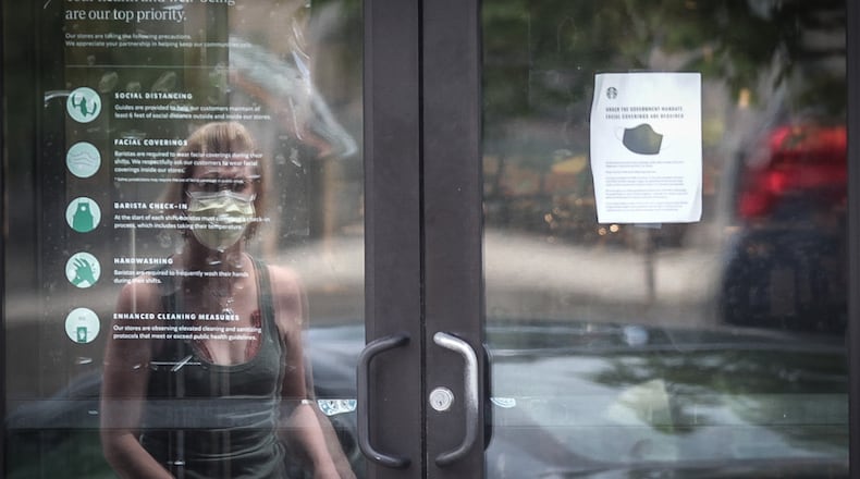 Many large retailers are now requiring that customers join their employees in wearing face masks to stop the spread of the coronavirus. Starbucks, Best Buy and Kroger have also announced mandatory masks nationwide in recent days. Starbucks and Best Buy started requiring that customers wear masks on July 15. Most people who entered the Starbucks on Far Hills Ave. in Oakwood were wearing masks. JIM NOELKER/STAFF