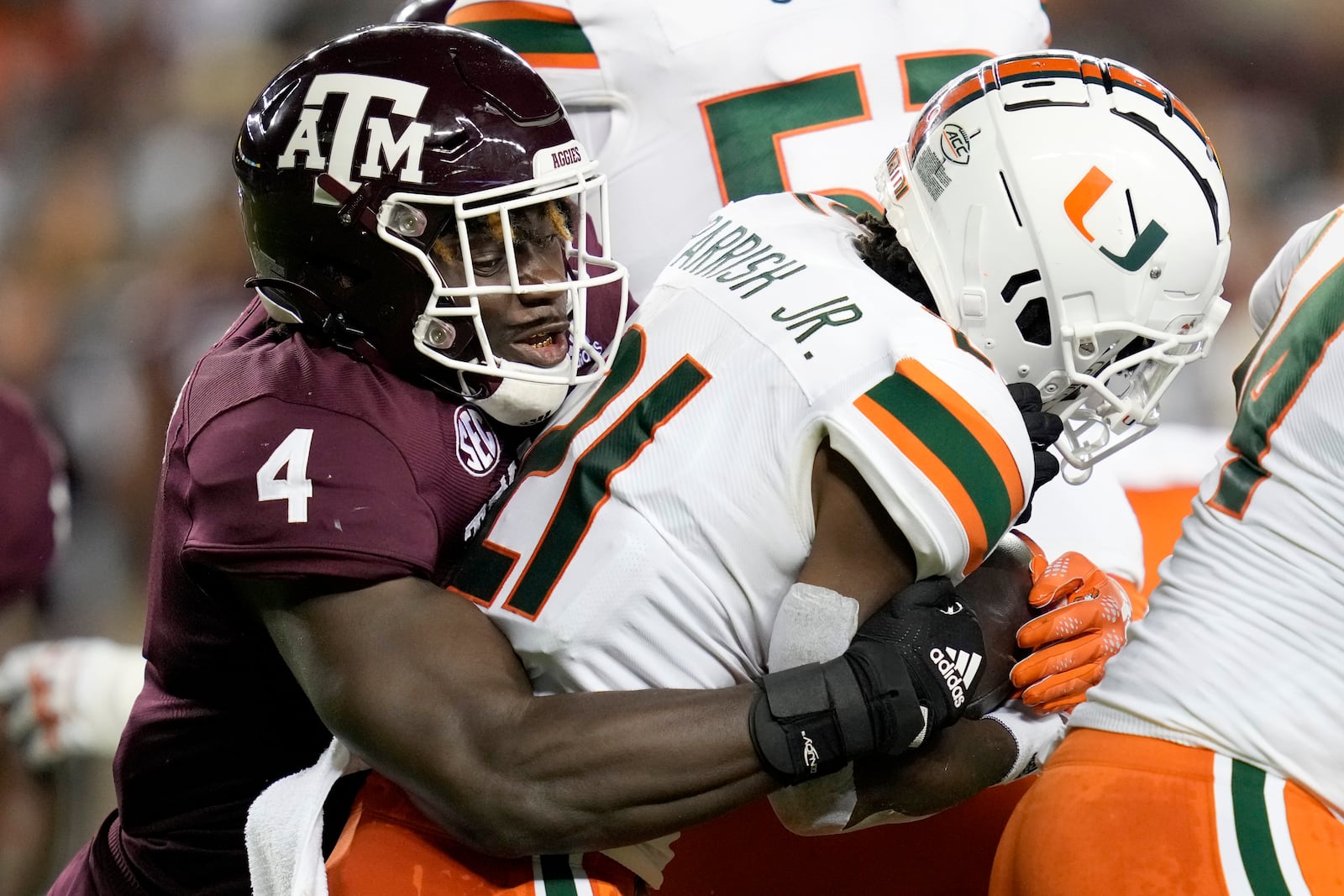 Texas A&M defensive lineman Shemar Stewart (4) tackles Miami running back Henry Parrish Jr. (21) for a loss during the first quarter of an NCAA college football game Saturday, Sept. 17, 2022, in College Station, Texas. (AP Photo/Sam Craft)