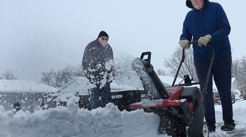 Theda and Bill Moorman clear the snow from their driveway at their home in Jamestown, Tuesday, Feb. 9, 2021. MARSHALL GORBY\STAFF