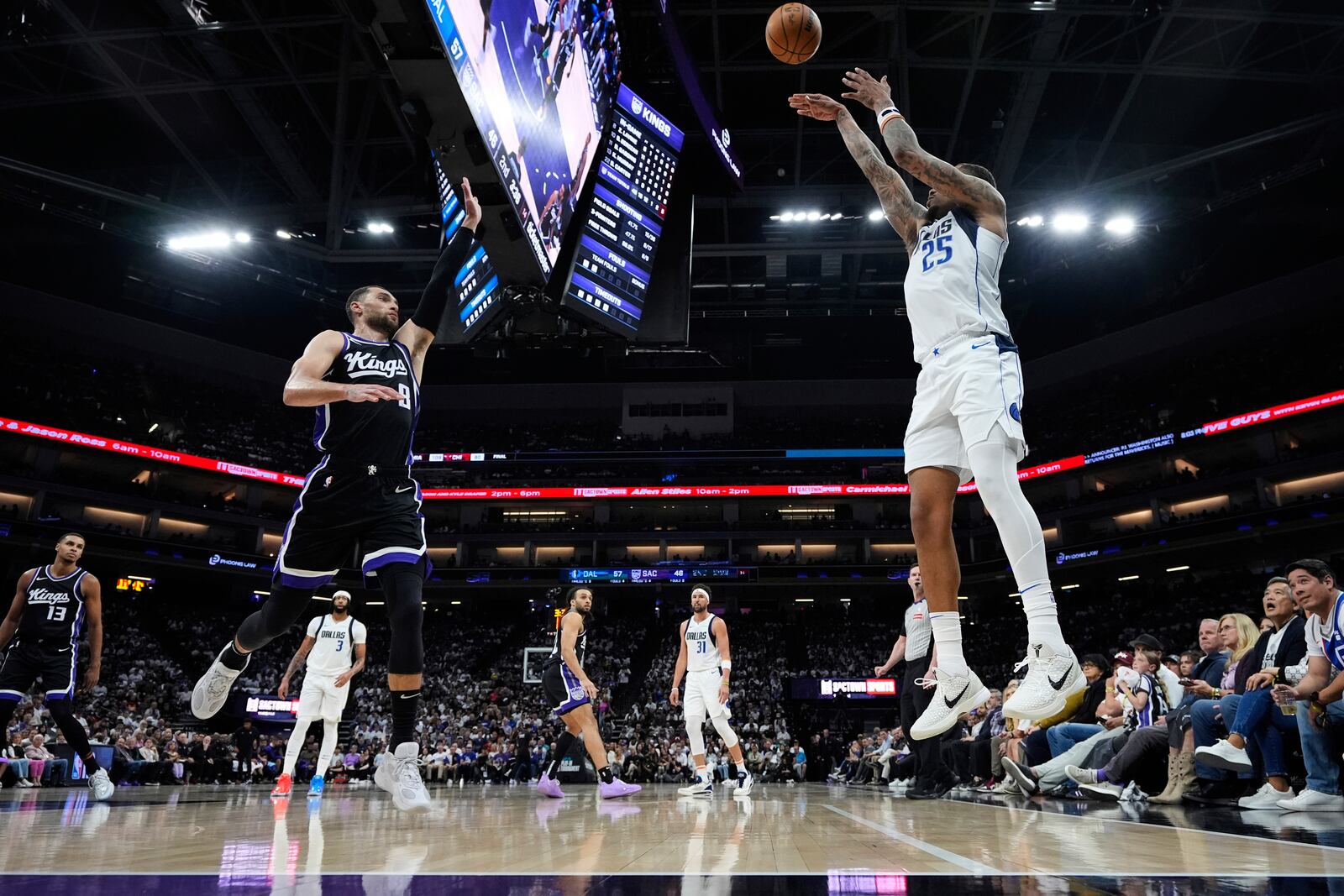 Dallas Mavericks forward P.J. Washington (25) shoots a 3-point basket over Sacramento Kings guard Zach LaVine (8) during the first half of an NBA play-in tournament basketball game Wednesday, April 16, 2025, in Sacramento, Calif. (AP Photo/Godofredo A. Vásquez)