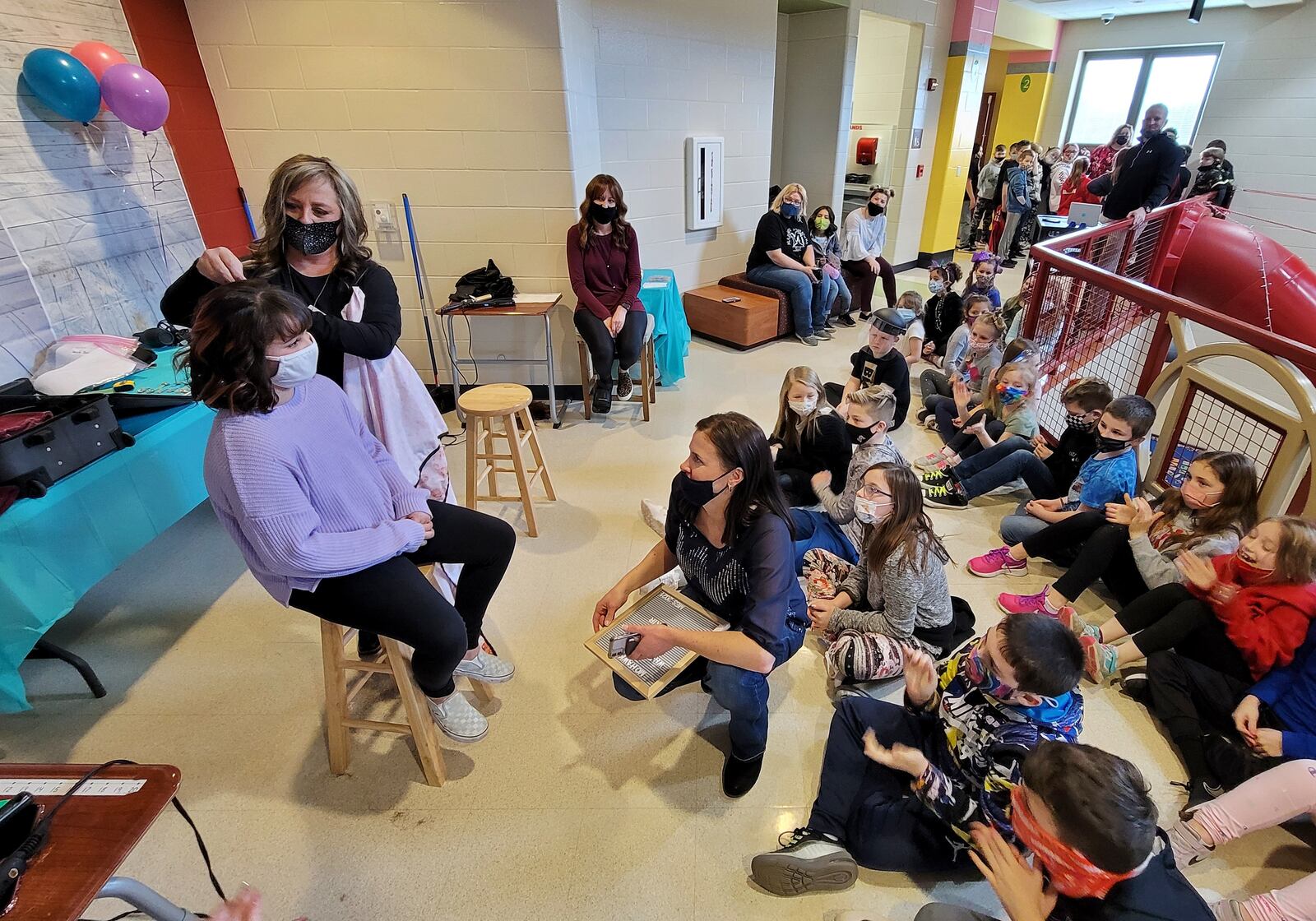 Jody Cole, from American Hair Company, cuts the hair of fourth-grader Sophia Muniz. Several Madison Elementary School students and teachers donated their hair Monday, March 1, 2021 to help others who made need it. NICK GRAHAM / STAFF