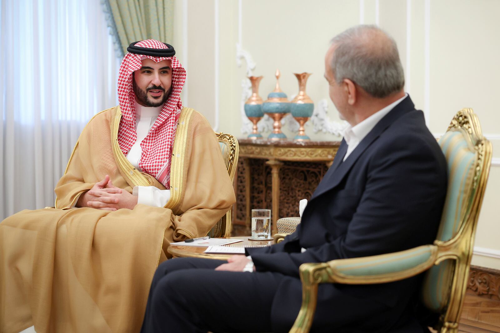 In this photo released by the Iranian Presidency Office, Saudi Arabia's Defense Minister Prince Khalid bin Salman, left, speaks with President Masoud Pezeshkian during their meeting, in Tehran, Iran, Thursday, April 17, 2025. (Iranian Presidency Office via AP)
