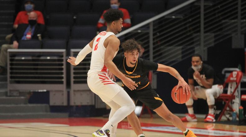 Dayton's Ibi Watson guards Northern Kentucky's Trey Robinson on Tuesday, Dec. 8, 2020, at UD Arena. David Jablonski/Staff
