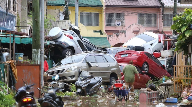 Vehicles lie piled on after flooding caused by Typhoon Kalmaegi in Cebu city, central Philippines, Tuesday, Nov. 4, 2025. (AP Photo/Jacqueline Hernandez)