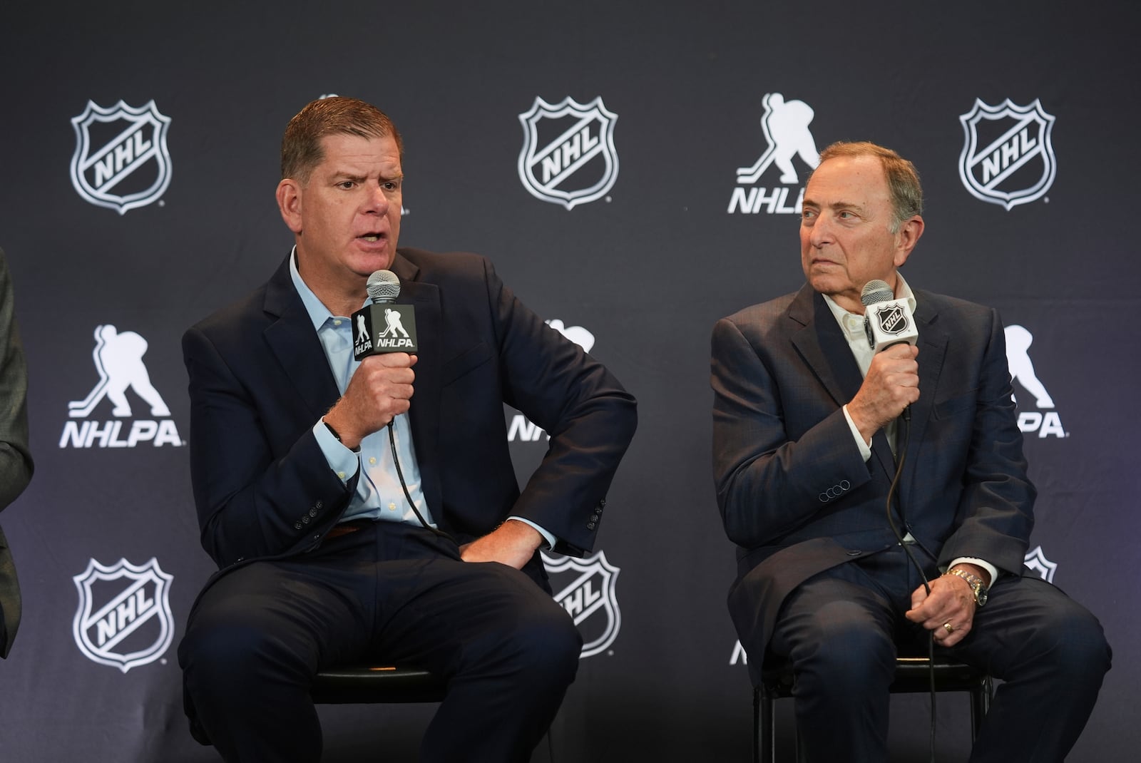 Marty Walsh, left, NHLPA Executive Director, and Gary Bettman, NHL Commissioner, conduct a joint press conference before the NHL hockey draft Friday, June 27, 2025, in Los Angeles. (AP Photo/Damian Dovarganes)