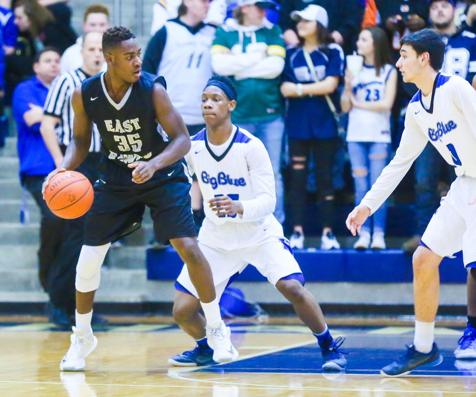 Lakota East guard Jarrett Cox (35) surveys the Hamilton defense during their game at the Hamilton Athletic Center on Feb. 10. GREG LYNCH/STAFF